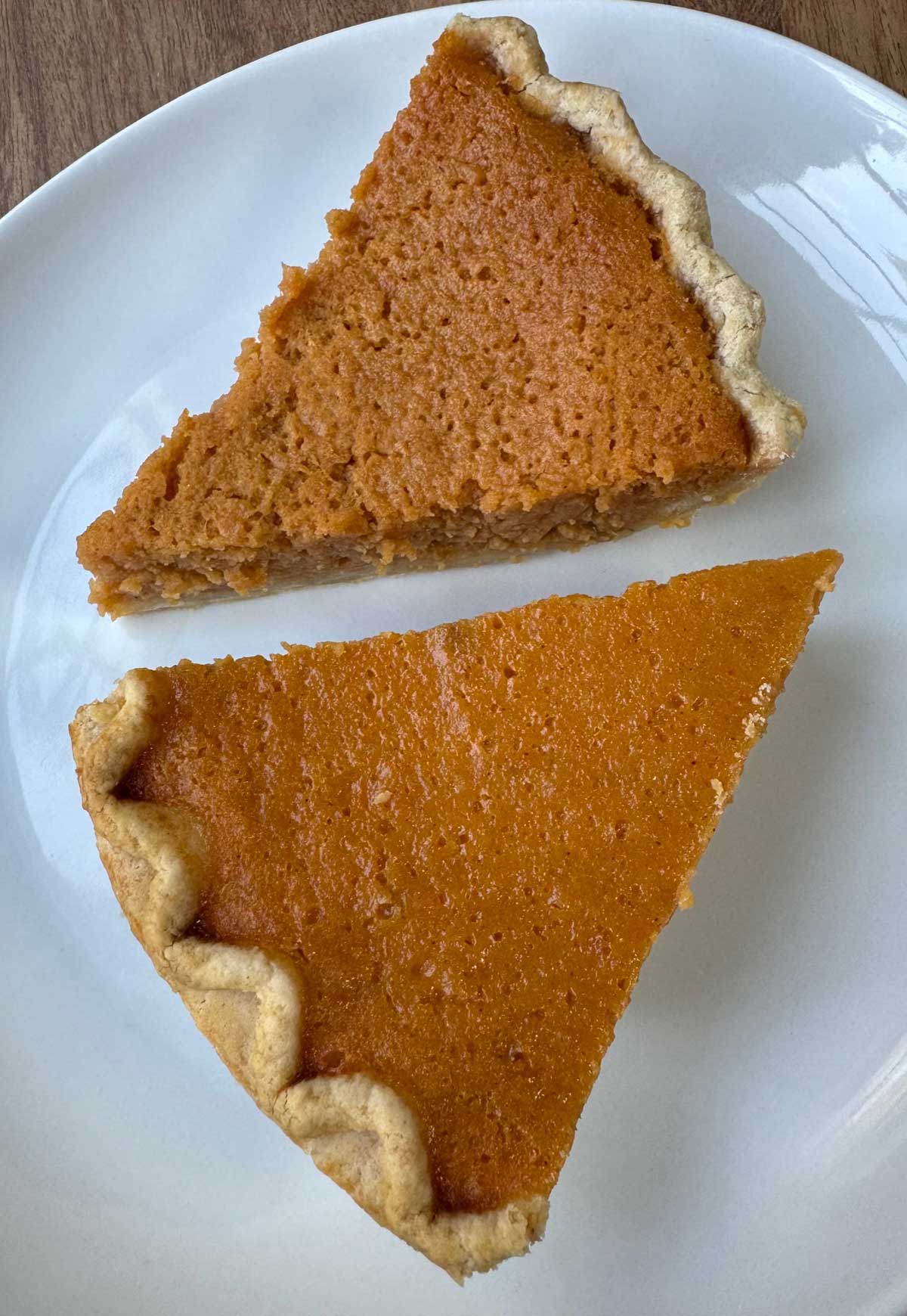 Two slices of different types of sweet potato pie, Mama Dip's vs. Ruth Reichl.