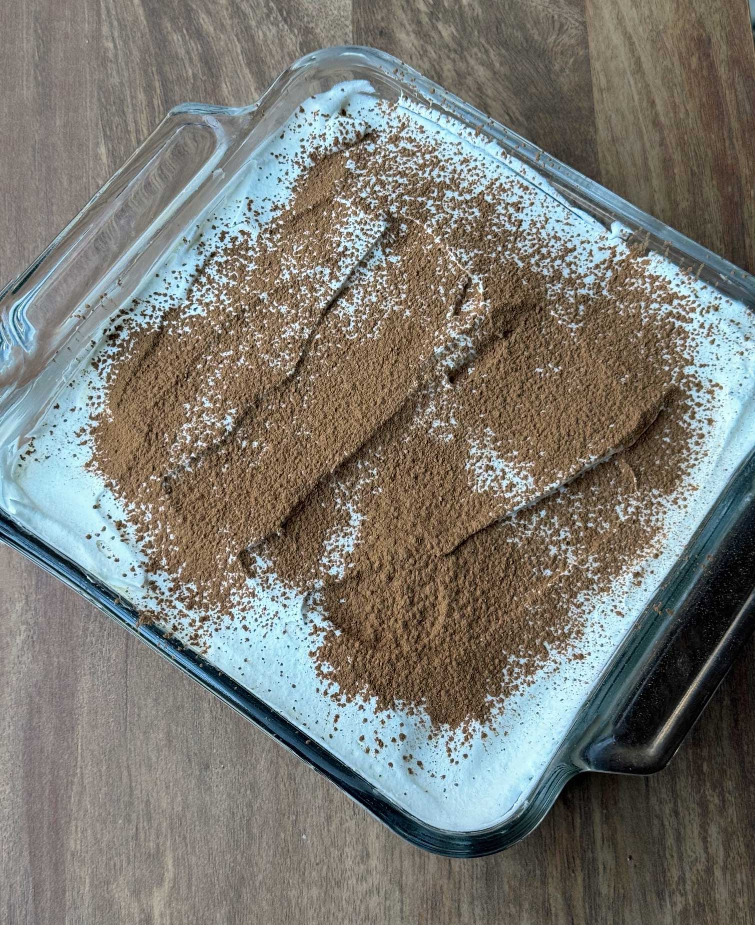 An 8-inch glass baking dish of tiramisu