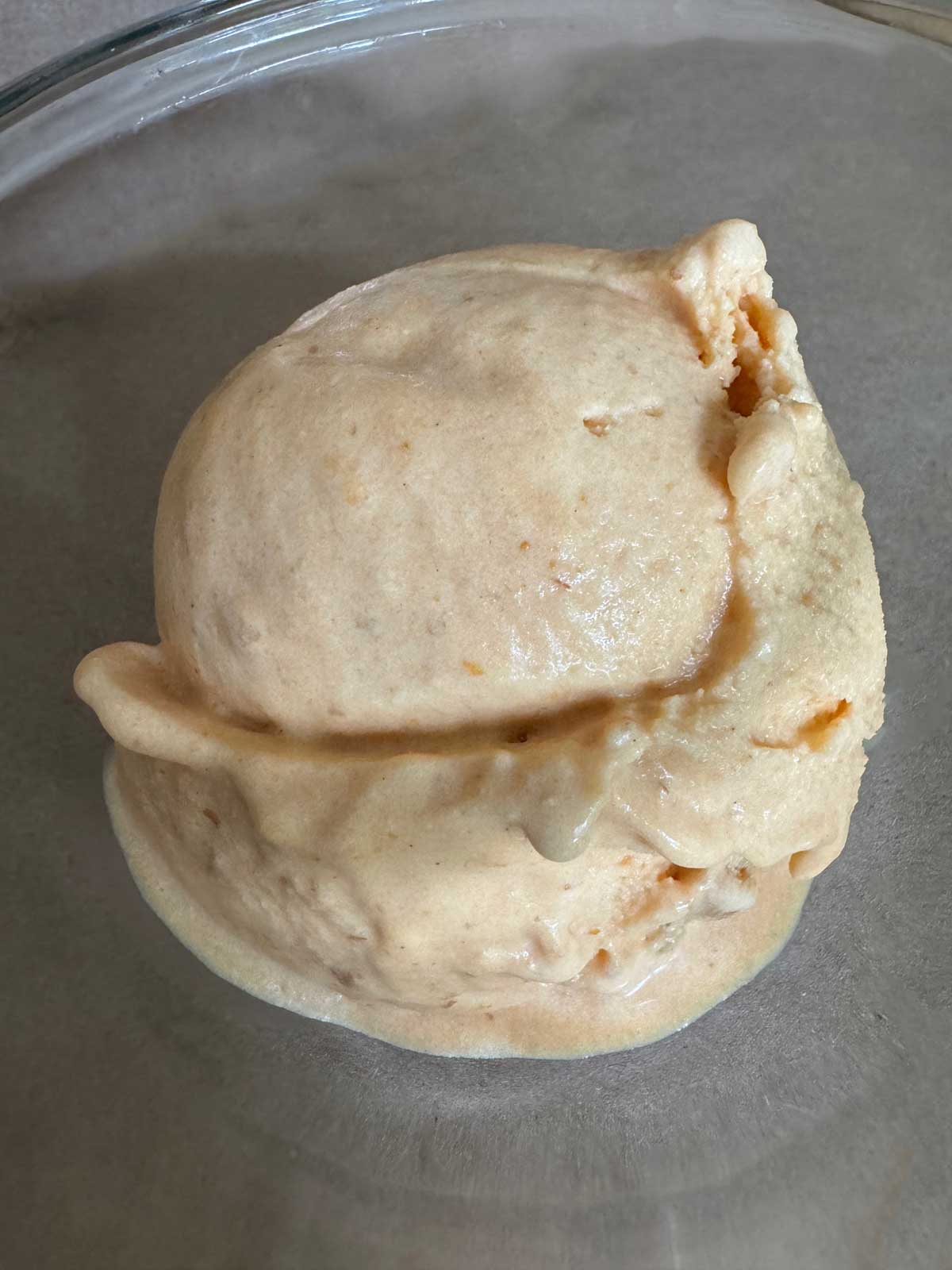 A scoop of pumpkin pie ice cream.