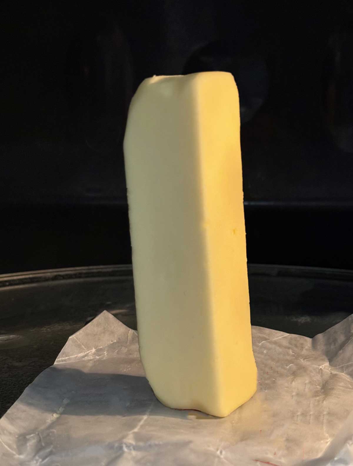 Trick for softening butter in the microwave by standing it on its end and heating for 6 seconds.