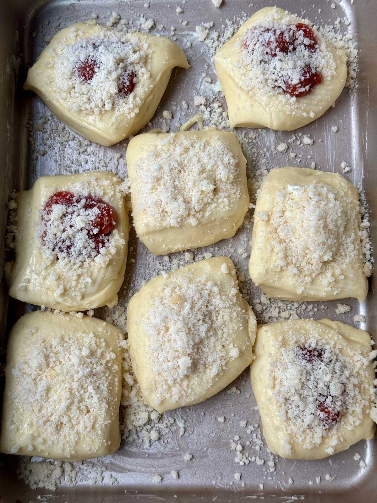 Unbaked kolaches in a pan showing spacing before being baked.