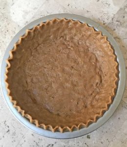 Unbaked pie shell with graham cracker flavored dough