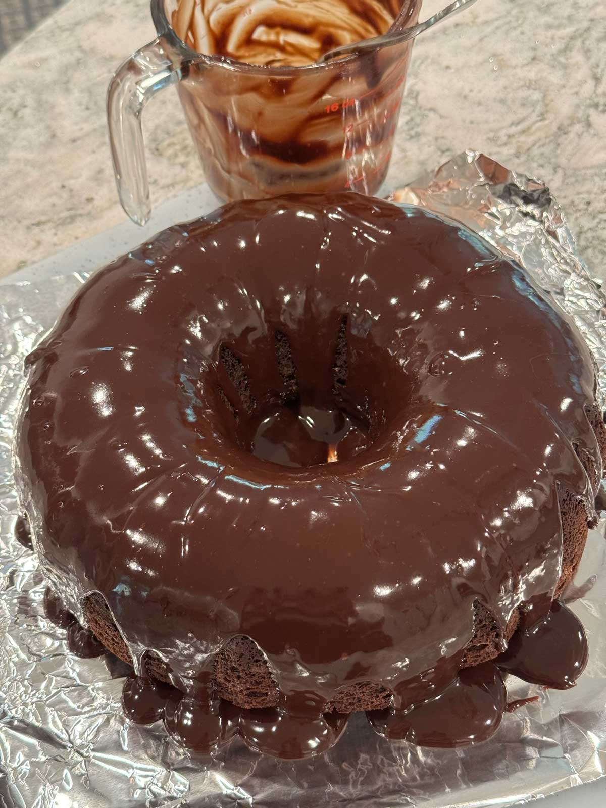 Chocolate ganache on a chocolate cheesecake Bundt cake.