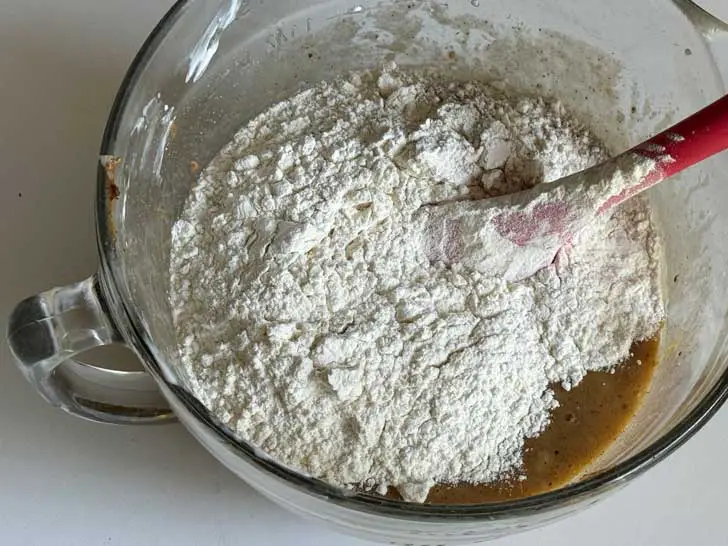 Flour being added to batter for Claire Saffitz Almond Butter Banana Bread