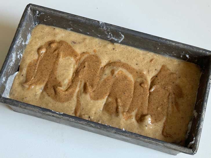 Dessert Person Banana bread batter in the pan with the almond butter swirl on top