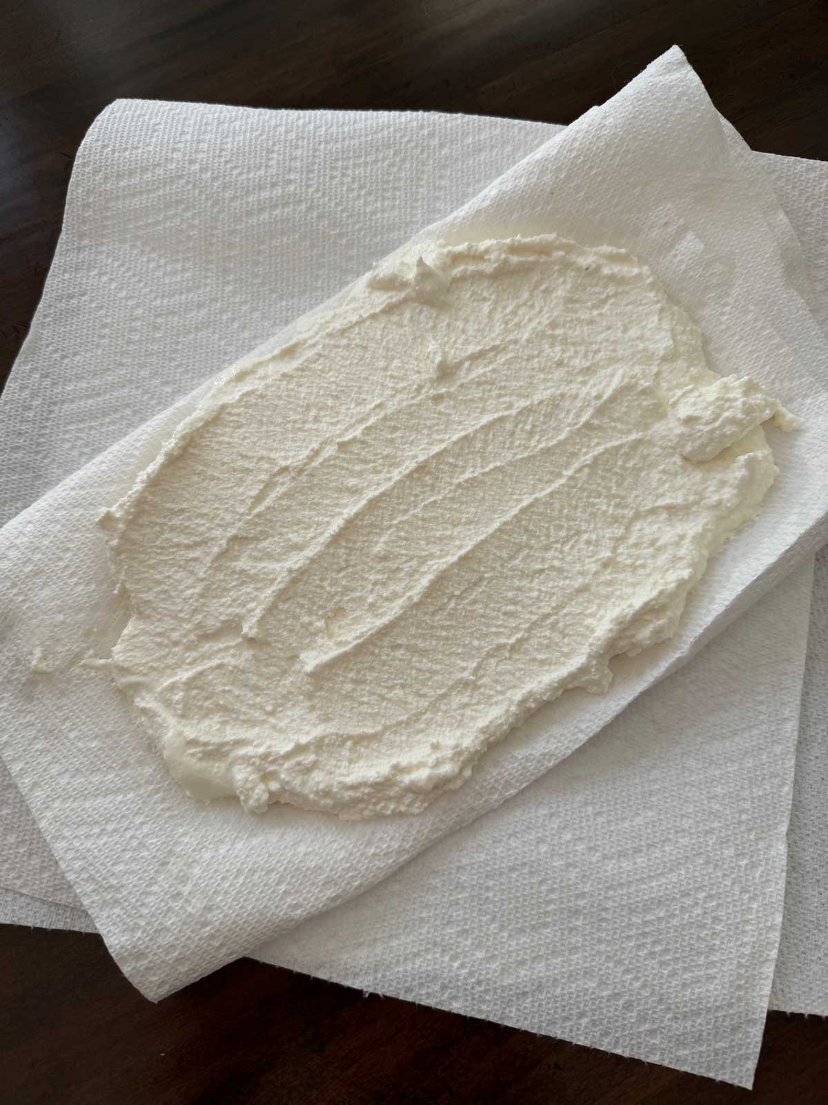 Draining ricotta cheese on paper towels for Ricotta Sour Cream Pie