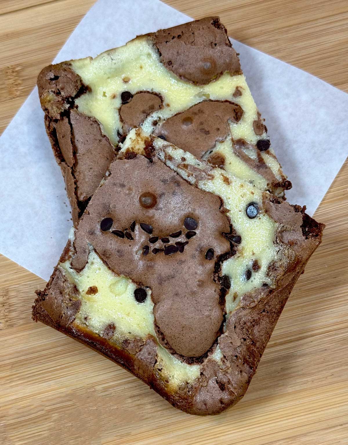 Corner pieces of marbled cream cheese brownies from an 8-inch square pan recipe.