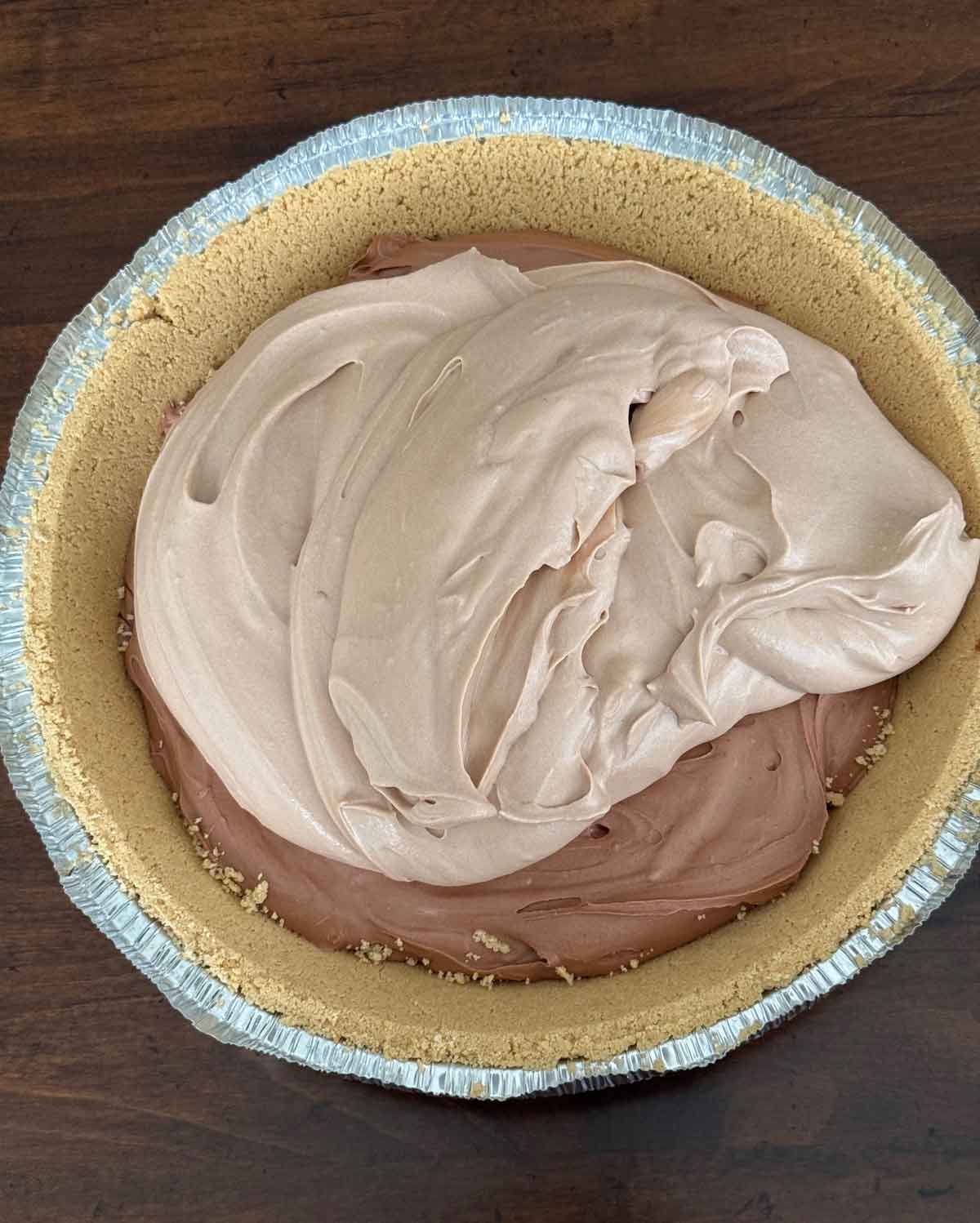 Layered Chocolate Cream Pie showing store bought graham cracker crust and a bittersweet and milk chocolate layer.