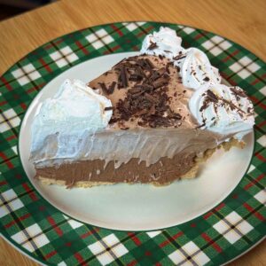 Slice of pie showing layers of bittersweet whipped cream and milk chocolate whipped cream.