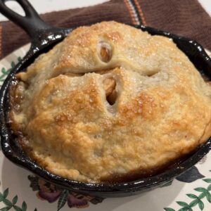 6-inch skillet apple pie in cast iron, still hot and bubbly.