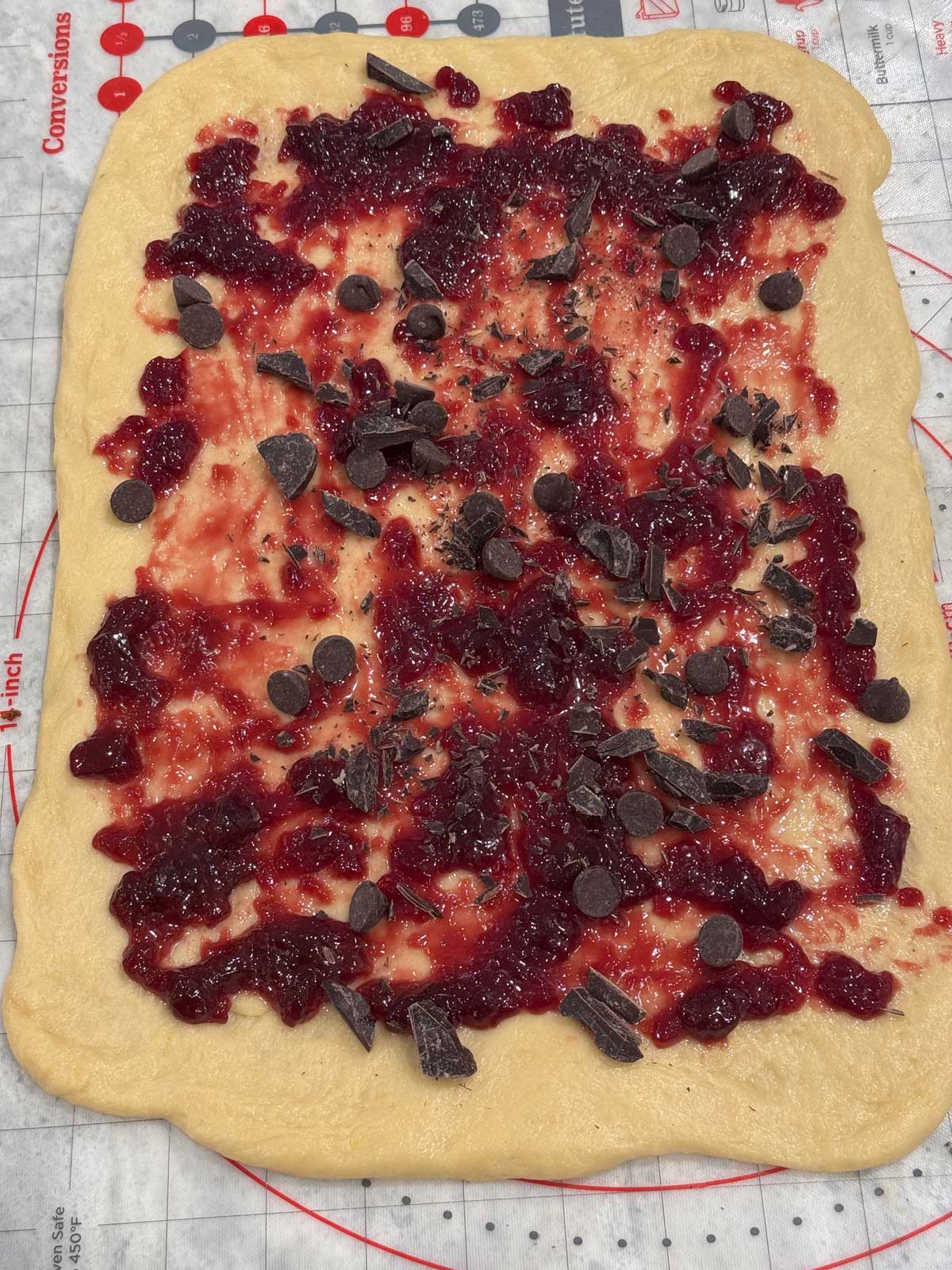 Babka dough with fruit preserves on top from a recipe that makes two loaves.