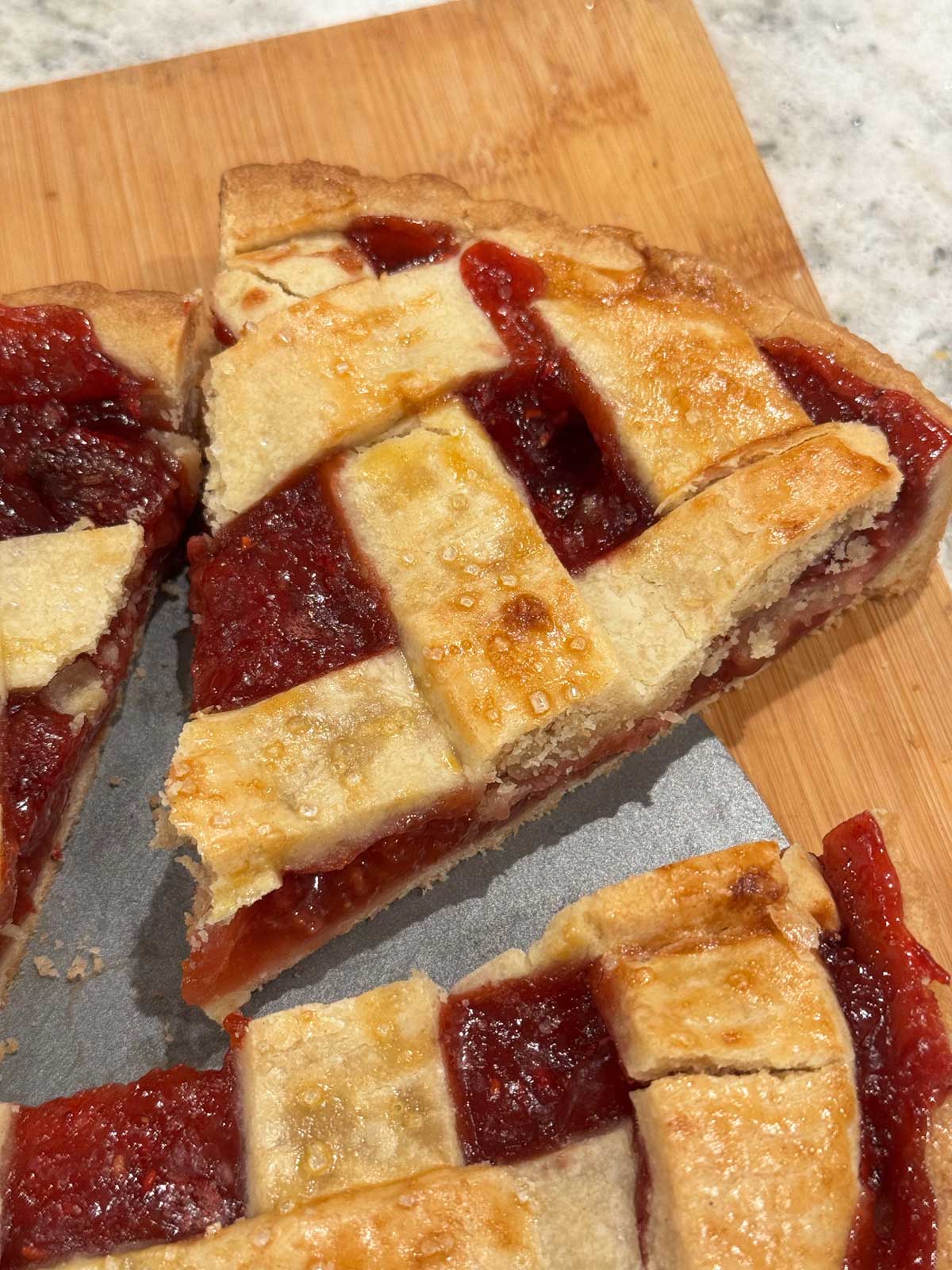 Strawberry Crostata being sliced for an Italian dessert tray.