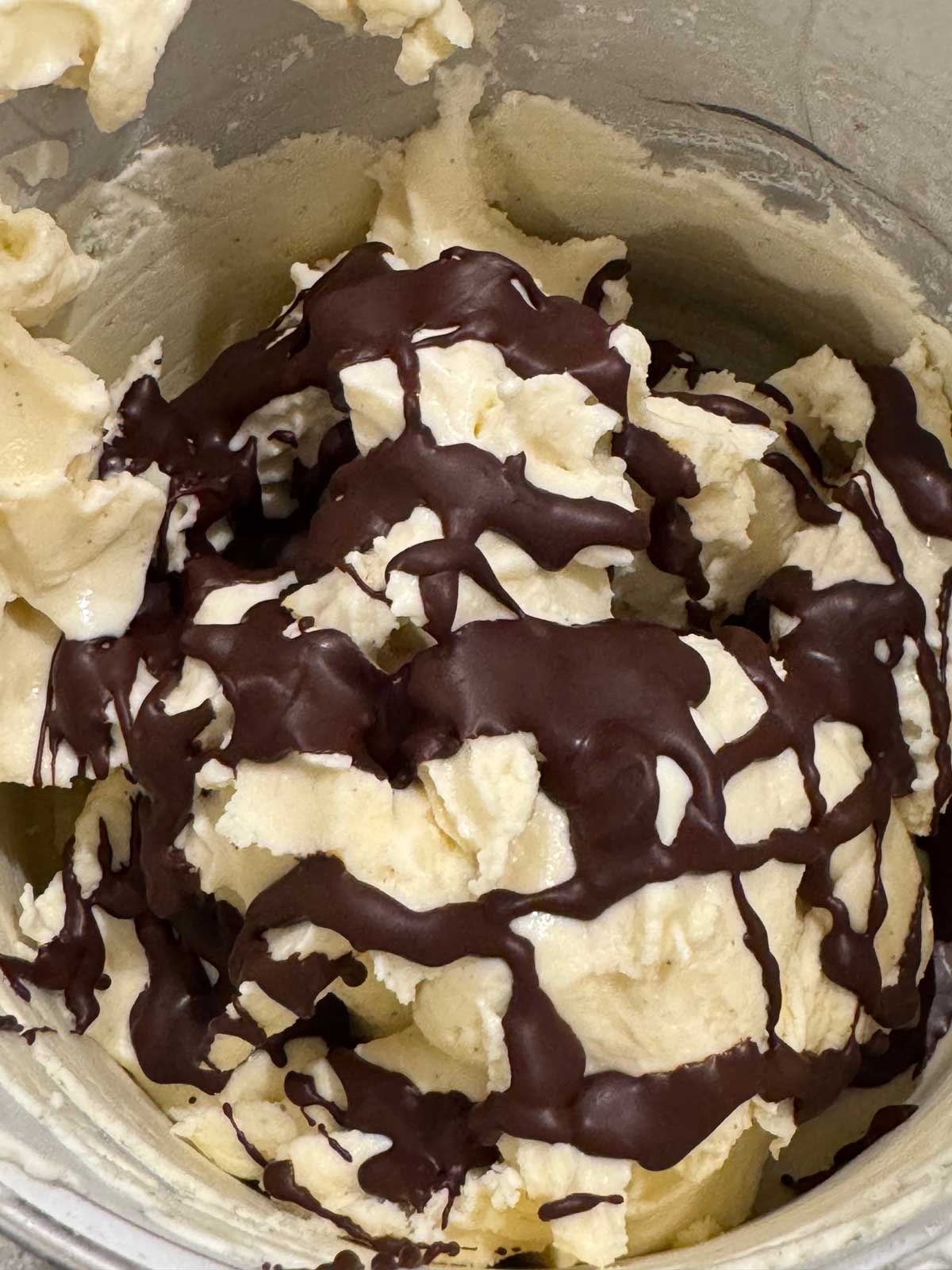 Ricotta cheese or cannoli themed ice cream with melted chocolate and coconut swirled through.