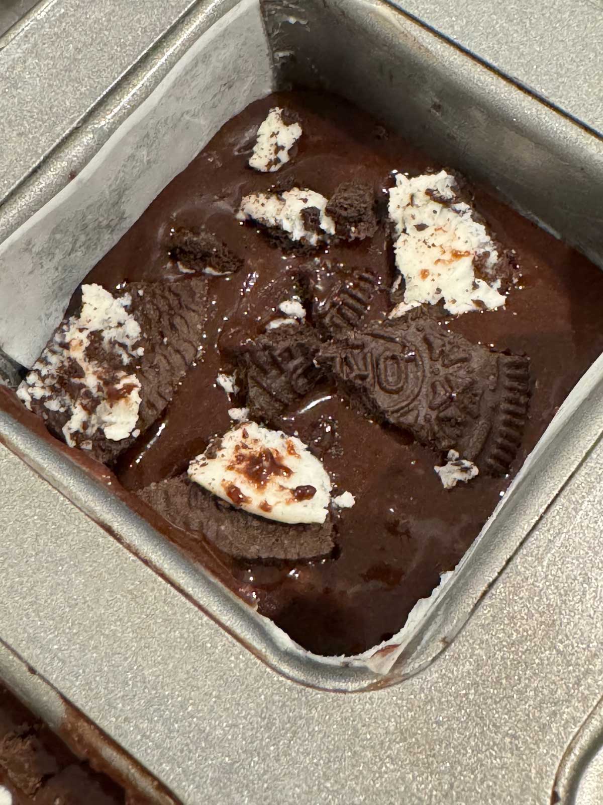 Crumble Brownies Copycat batter in a square muffin pan.