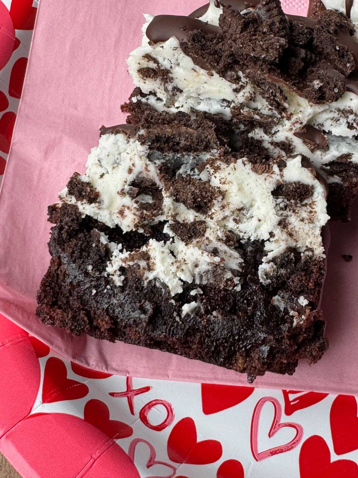 Crumble Oreo Brownie Copycat split in half to show texture of cream cheese frosting.