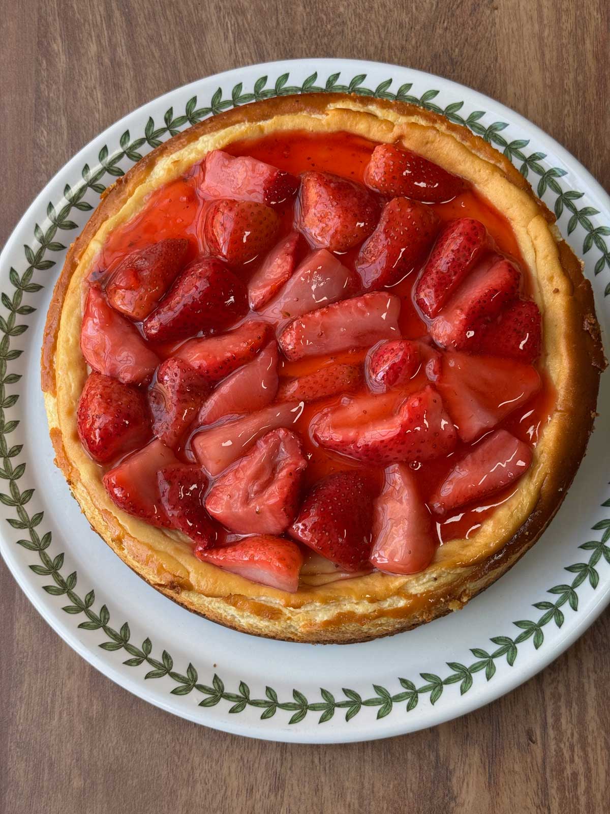 A whole keto strawberry cheesecake or New York style cheesecake with a strawberry topping